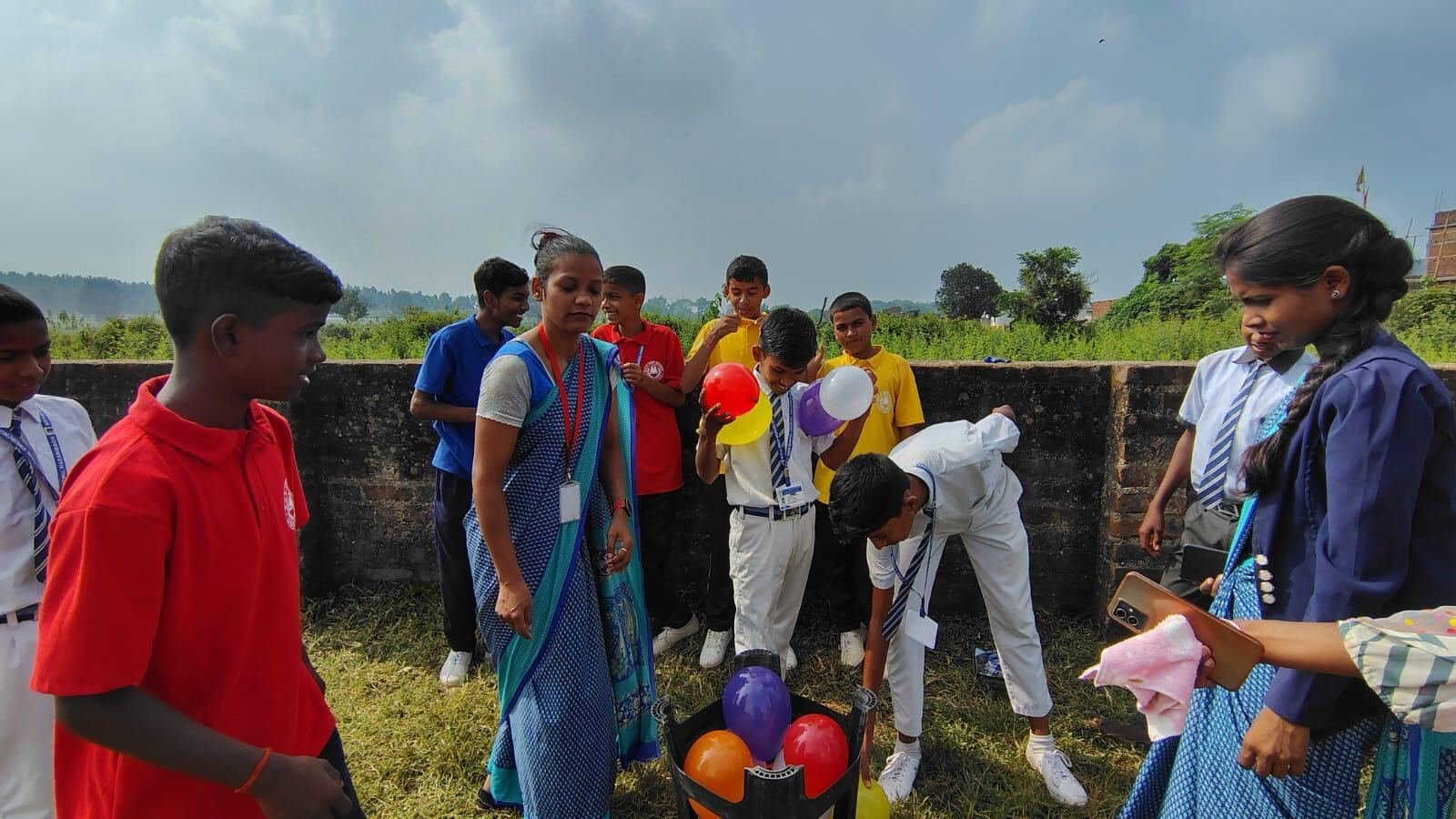 Students playing a balloon game in the school courtyard