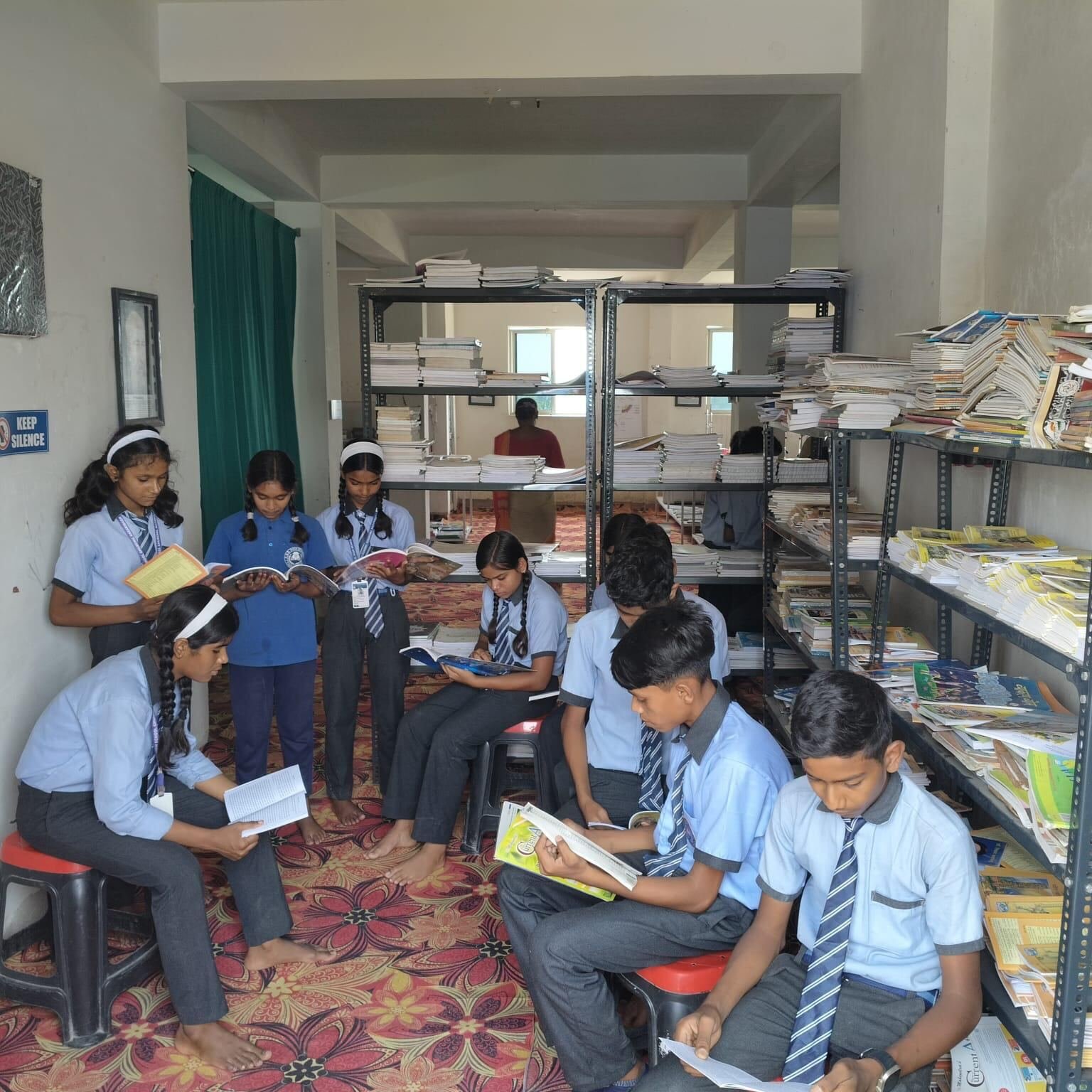 Students sitting in a circle reading books in the RGS library